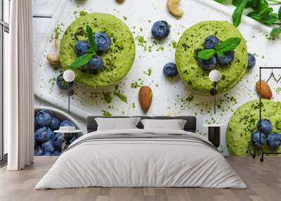 homemade raw matcha powder cakes with fresh berries, mint, nuts. healthy vegan food concept Wall mural