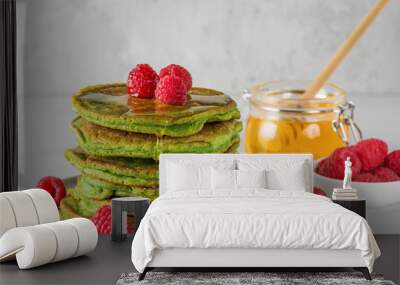 Matcha tea green pancakes. Pile of homemade pancakes with fresh raspberries and honey. healthy breakfast dessert Wall mural