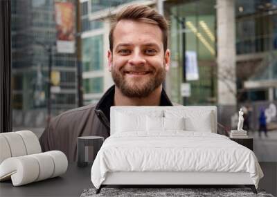 Man with a beard smiling in downtown Toronto with sky rise buildings in the background Wall mural