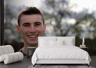 Portrait head shot of a teenage boy smiling Wall mural