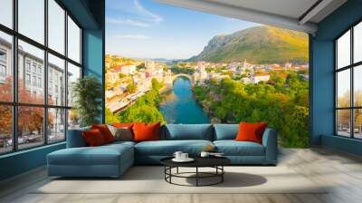 Fantastic Skyline of Mostar with the Mostar Bridge, houses and minarets, during sunny day. Location: Mostar, Old Town, Bosnia and Herzegovina, Europe Wall mural