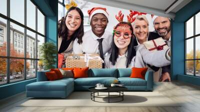 Friends, selfie and business people at christmas party in the office with silly accessories. Diversity, smile and happy corporate colleagues taking picture together with gifts at festive celebration. Wall mural