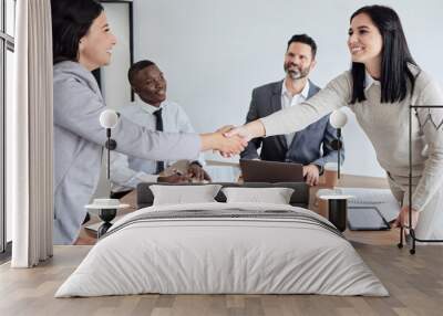 Meeting, welcome and business women shaking hands in the boardroom for a b2b partnership or deal. Thank you, handshake and support with happy female colleagues in agreement while planning at work Wall mural