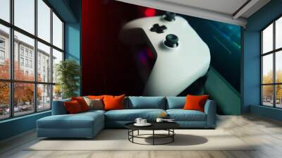 The mancave awaits. High angle shot of a console remote on a desk in a dark gaming room. Wall mural