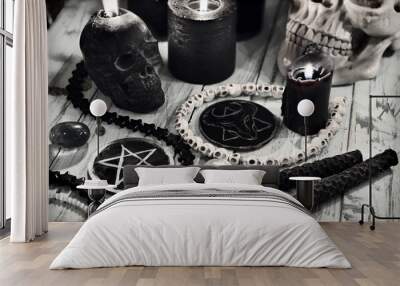 Evil still life with black candles and scary symbols of devil with pentagram. Wall mural