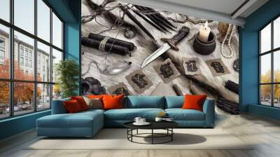 Styled still life with runes, ritual knife and black candles on witch table. Wall mural