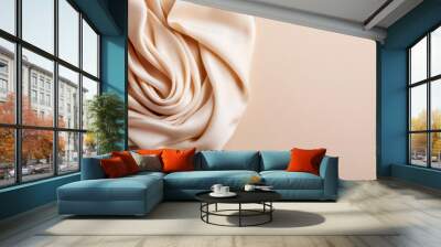 Elegant closeup of soft, flowing beige silk fabric with pleated folds on a smooth light background. Ideal for backgrounds, designs, and textures. Wall mural