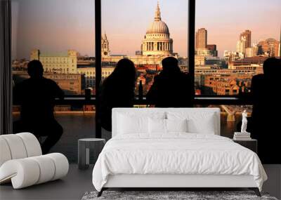 A couple tourists overlooking St Paul's Cathedral and Millennium Bridge at Sunset. Wall mural