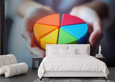 A person holding a pie chart showing asset allocation in a diversified investment portfolio. Wall mural