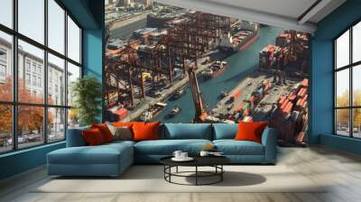 An aerial view of a busy industrial harbor with ships docking, cranes loading cargo, and shipping containers stacked high. Wall mural