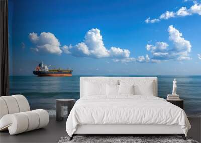 Tranquil Seascape with Cargo Ship and Blue Sky Wall mural