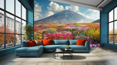 A panoramic shot of a mountain in paradise surrounded by fields of colorful flowers Wall mural