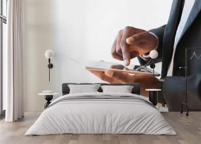 African american business man using a tactile tablet over white Wall mural