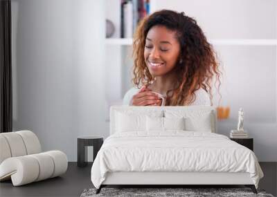 African American woman in her living room drinking holding a cof Wall mural