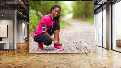 African american woman runner tightening shoe lace - Fitness, pe Wall mural