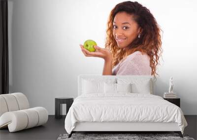 African Americanyoung woman holding one green apple - Black peop Wall mural