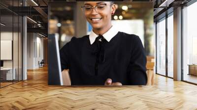 Black  African American coworkers doing digital teamwork arround a coffee cup Wall mural