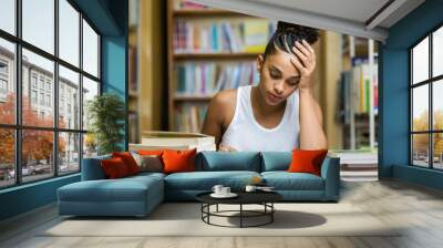 Black african american young girl student studying at the school university library Wall mural