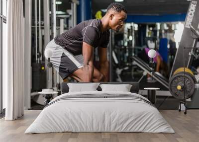 Black African American  young man doing  workout at the gym Wall mural