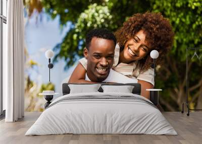 Outdoor protrait of black african american couple - Guy carrying girfriend on his back Wall mural