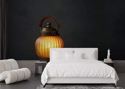 A lit, round, antique lantern with a leather handle and a brass base sits on a white marble surface against a dark grey backdrop. Wall mural