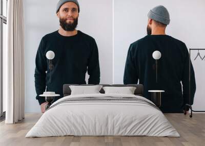 City portrait of handsome hipster guy with beard wearing black blank hoody or sweatshirt with space for your logo or design. Front and back view mockup Wall mural