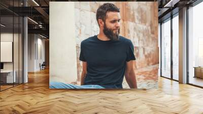 Handsome hipster man with beard wearing black blank t-shirt with space for your logo or design. black t shirt mockup. Wall mural