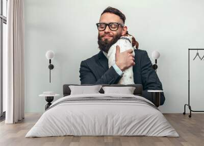 Handsome man with beard in formal suit hugs his cute dog Jack Russell Terrier isolate over white background. Animal lover. Friendship concept. Wall mural