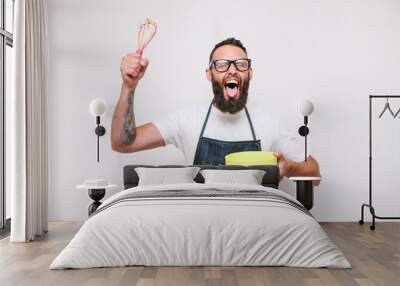 Portrait of a happy young crazy chef cook isolated on a white background Wall mural