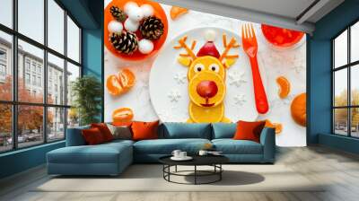 Fun Christmas food art idea - edible reindeer from orange slices on white plate, healthy fruit snack for kids Wall mural