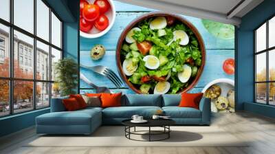 Green vegetable salad with cherry tomatoes quail eggs and olive oil dressing Wall mural