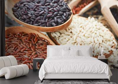 Set of rice in wooden spoons - brown rice, red rice, black rice Wall mural