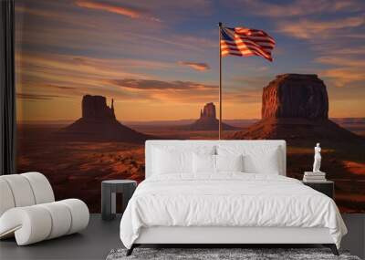 An American flag flying from a tall mast at the edge of a vast desert landscape at sunset. Wall mural