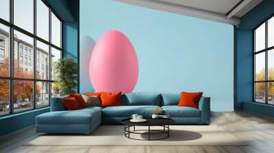 Picture the simplicity of Easter captured in a single pink egg against a solid background Wall mural