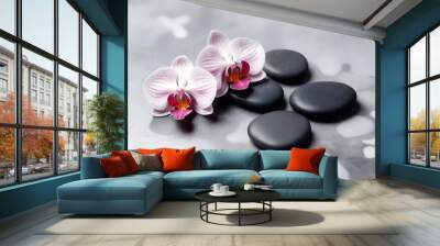 black spa stones with two pink and white orchid flowers on a reflective grey surface Wall mural