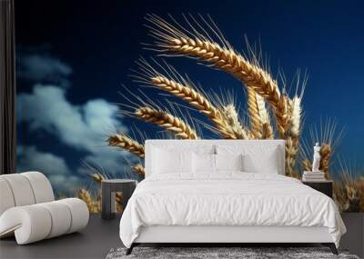 A golden wheat field swaying under a deep blue sky, the sunlight catching each stalk and creating a rich, vibrant contrast between the warm yellow and cool blue Wall mural