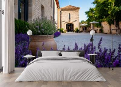 An intimate wedding ceremony taking place in the courtyard of a historic building in Avignon, surrounded by blooming lavender Wall mural