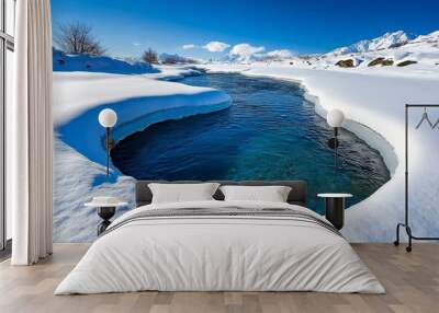 Winter nature landscape where a river flows gently through the snow, creating a beautiful contrast between ice and water Wall mural