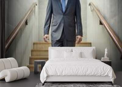 A man in a business suit is walking up the stairs. He has a TV instead of a head. Wall mural