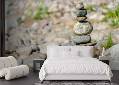 Pyramid of stones. Unstable balance of stone objects. Idyllic state of nature. Wall mural