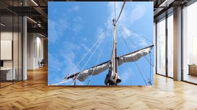 Tigging and masts of an old sailing ship against the blue sky with clouds. Travel adventure and travel concept, copy space. Wall mural