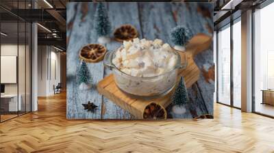 Fruit salad in a glass bowl on a wooden table. Typical christmas salad. Wall mural