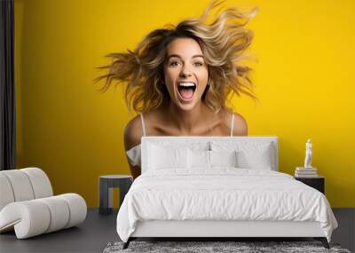 background yellow isolated upside hanging excited happy jumping woman blonde young Beautiful action active adult air attractive blond casual attire caucasian cheerful cool curly hair down energy Wall mural