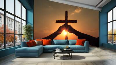 Christian religious concept. Silhouette Hands touching reaching for cross at sunset with glow and ray of the sun sunset. crucifixion pray, Biblical bible theme concept	
 Wall mural