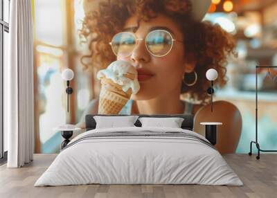 Radiant curly hair woman enjoying ice cream in cozy ice cream cafe, spring summer in vintage soft surrounding setting. Natural lighting.  Wall mural