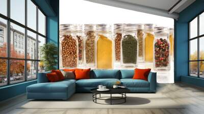 Assorted spice bottles isolated on white Wall mural