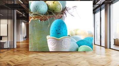 Easter scene with turquoise speckled egg in cup Wall mural