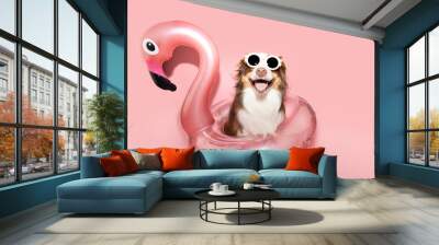 Portrait summer Australian Shepherd dog  puppy going on vacations inside a flamingo float. Isolated on Pink pastel color solid background Wall mural