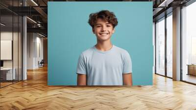 smiling boy portrait background caucasian blue happy face wearing photogenic casual camera isolated attractive arms crossed teenage tshirt attire young man Teenager looking Positive studio standin Wall mural