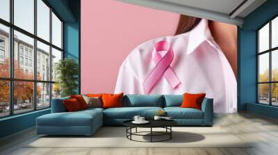 pink ribbon pinned to a white shirt, with a soft pink background emphasizing the message of hope - breast cancer awareness Wall mural